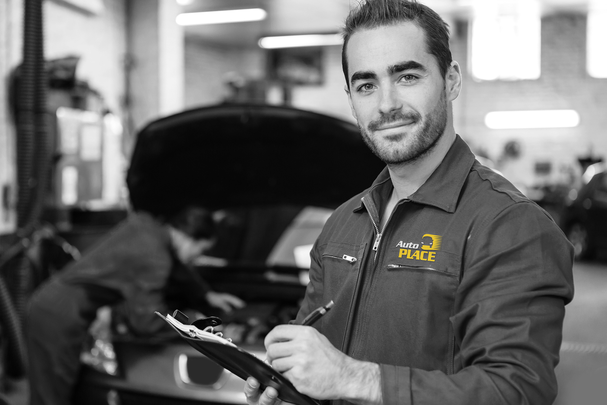 Young attractive mechanic working at the garage